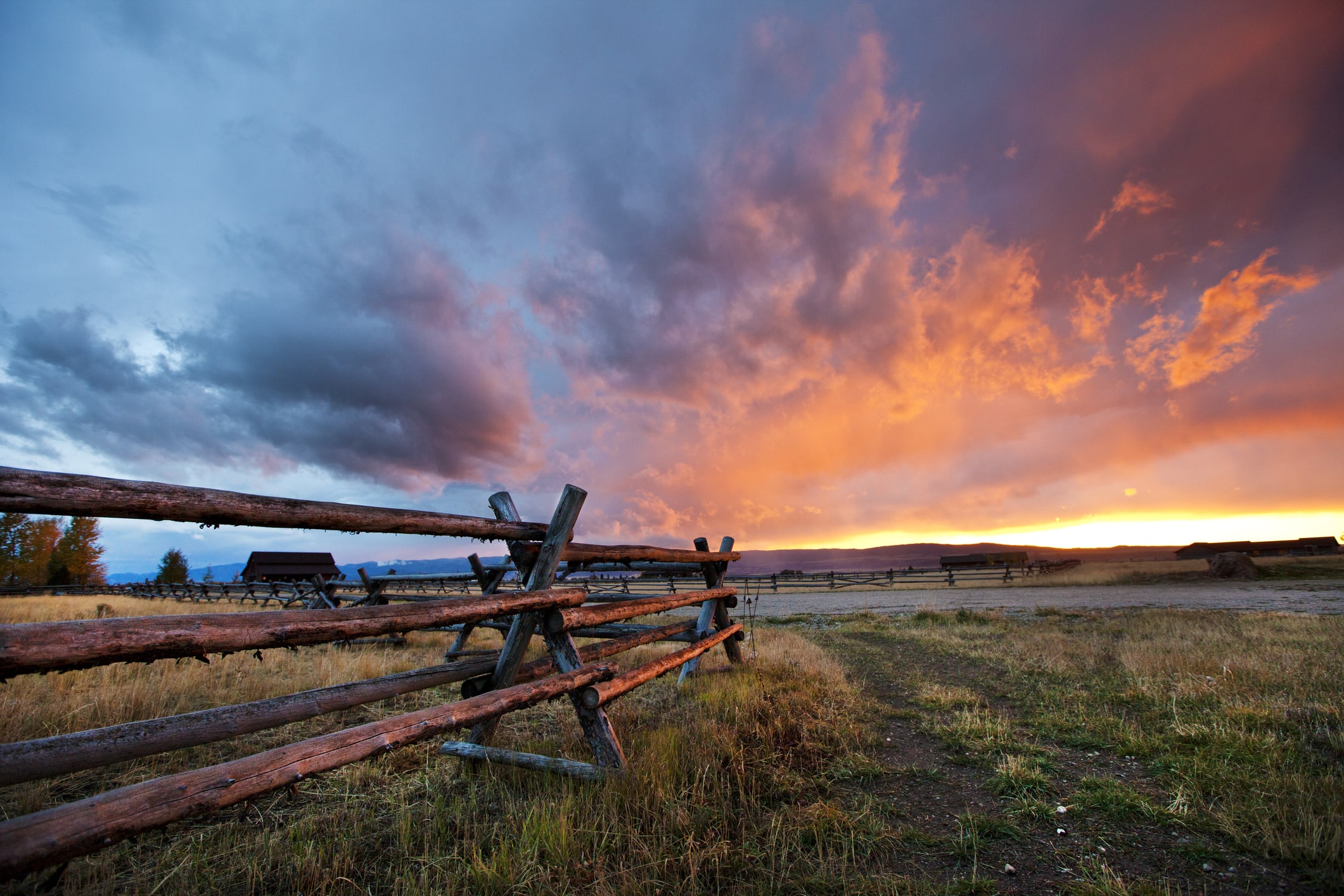 Sun setting over a ranch fence in Idaho.
